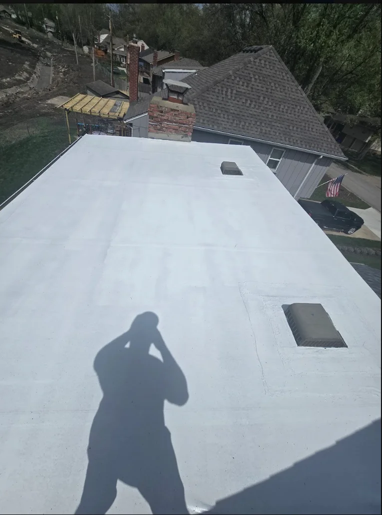 White flat roof membrane installation with roof vents and sealed penetrations