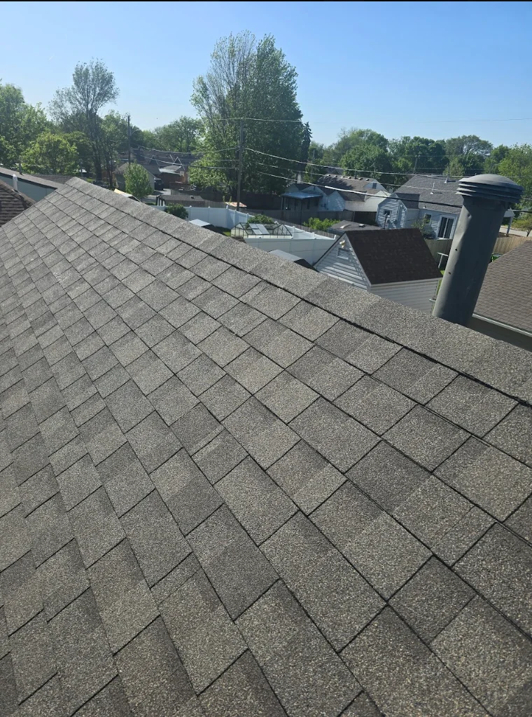 Gray asphalt shingles installed in staggered pattern with roof penetration flashing