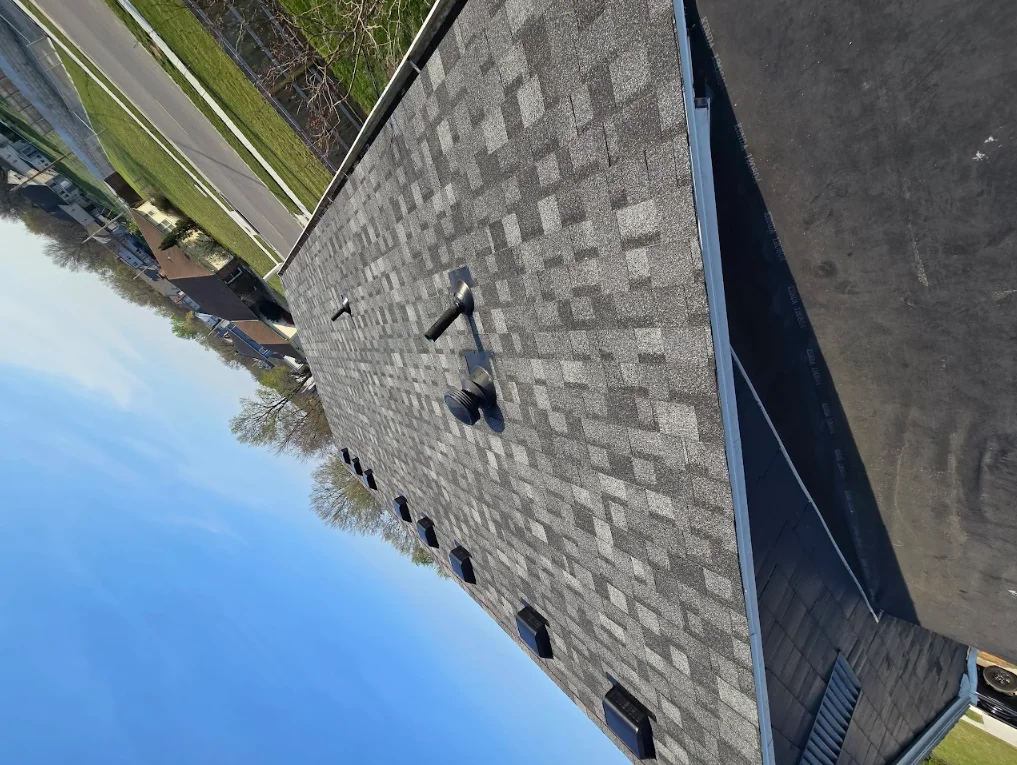 Gray architectural shingles installed on pitched residential roof with clean lines and proper alignment